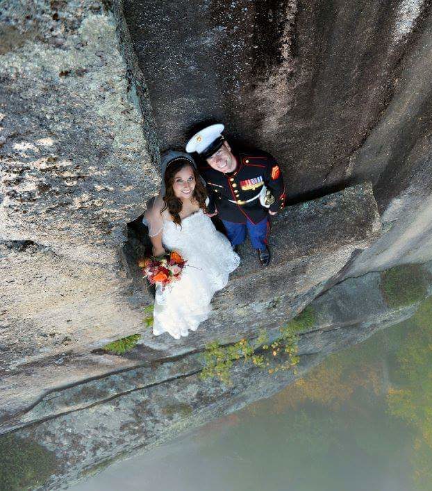 Bride and Groom standing on cliff.