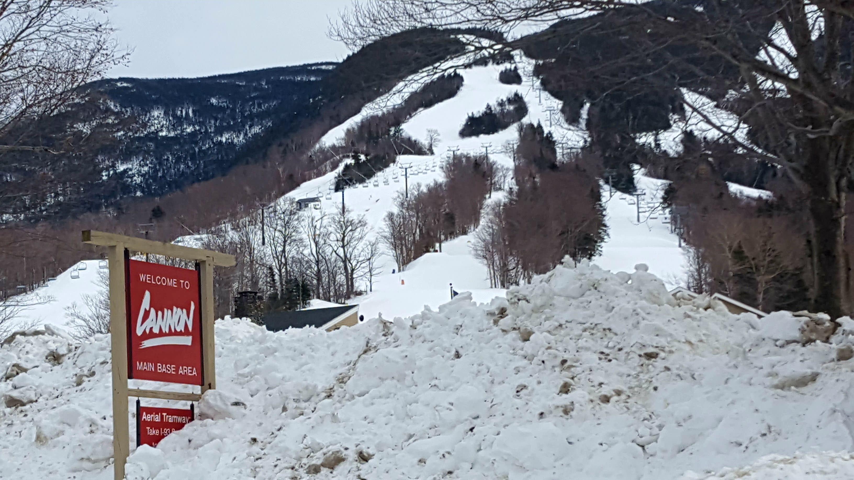 Cannon welcome sign half covered in snow.